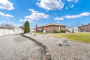 View of side of home featuring a yard