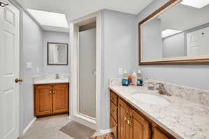 Bathroom with vanity and a shower with shower door