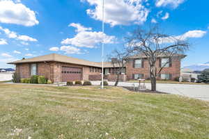 View of front of house with a garage and a front yard