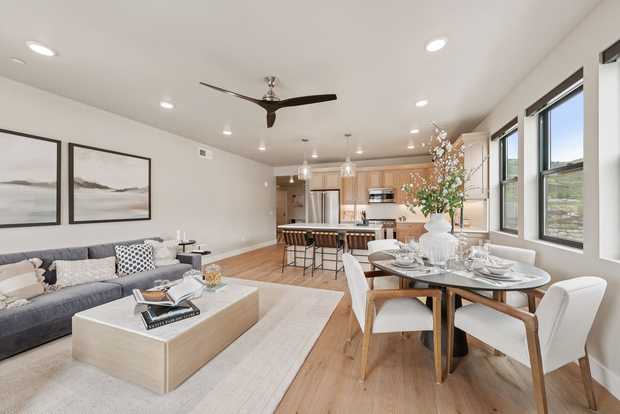 Living room with light wood-type flooring, recessed lighting, and ceiling fan