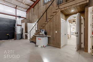 Basement featuring wood walls