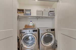 Washroom featuring washer and clothes dryer