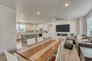 Dining room with light hardwood / wood-style floors and ceiling fan