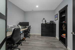 Office with a secret room discreetly concealed behind the shelving.