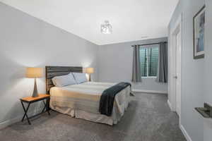 Generous bedroom featuring neutral carpet and a walk-in closet.