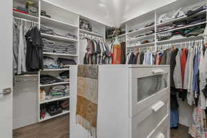 Expansive walk-in closet in the primary suite, complete with a central island for added storage.