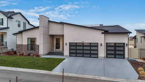 Contemporary home featuring a finished three car garage and 34 solar panels.