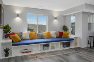 Oversized built-in window seating adorns the side of the recreation room.