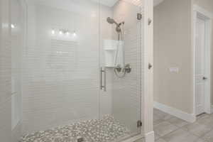 Primary en suite  equipped with a sleek Euro-style shower.