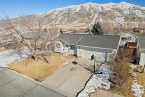 View of front facade featuring a garage and a mountain view