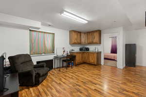 Kitchen featuring a textured ceiling and light hardwood / wood-style floors