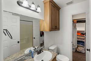 Bathroom featuring vanity and toilet