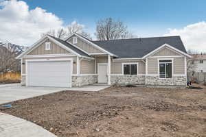 Craftsman-style home with a garage and a mountain view