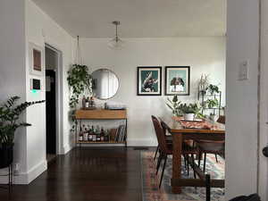 Dining space with dark wood-type flooring and a textured ceiling