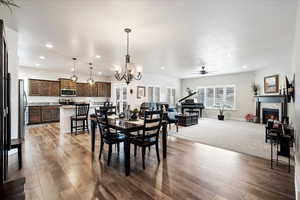 Dining area featuring hardwood / wood-style flooring and ceiling fan with notable chandelier