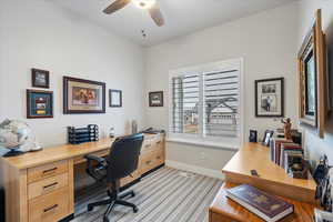 Carpeted home office with ceiling fan