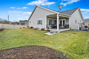 Rear view of house featuring a wooden deck, a yard, and french doors