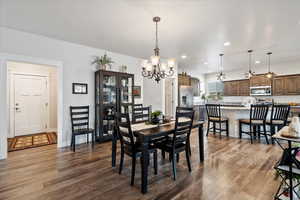 Dining area featuring a chandelier and dark hardwood / wood-style flooring