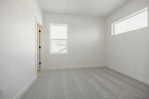 Unfurnished room featuring light colored carpet