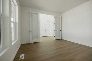 Empty room featuring hardwood / wood-style flooring