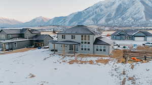 Snow covered house with a mountain view