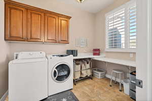 Laundry area with cabinets and washer and dryer