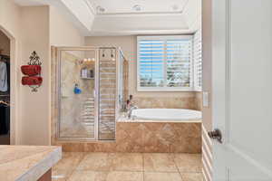 Bathroom featuring independent shower and bath and tile patterned flooring