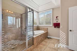 Bathroom featuring tiled bath and a wealth of natural light