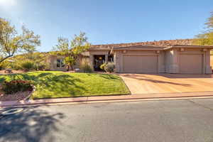 View of front of home featuring a garage and a front lawn