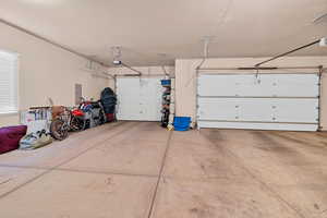 Garage featuring a garage door opener and electric panel