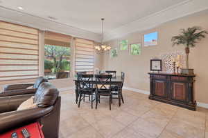 Tiled dining area with a wealth of natural light and a chandelier