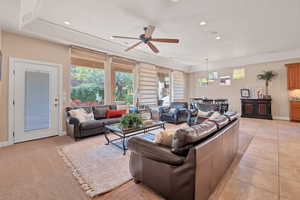 Tiled living room featuring ceiling fan