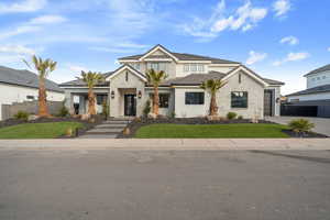 View of front of home featuring a garage and a front yard