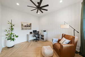 Office space with ceiling fan and light parquet flooring