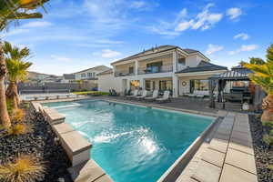 View of swimming pool with a gazebo and a patio