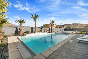 View of swimming pool with a mountain view and a patio area