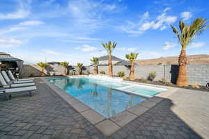 View of pool with an in ground hot tub, a gazebo, and a patio