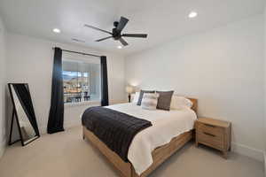 Carpeted bedroom with ceiling fan