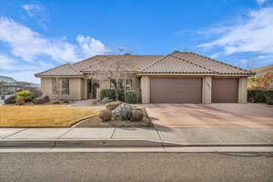 View of front of house with a garage and a front yard