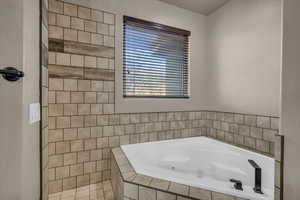 Bathroom featuring a relaxing tiled tub