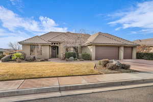 View of front of home featuring a garage and a front yard