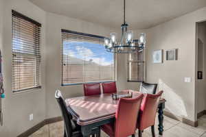 Tiled dining room with an inviting chandelier