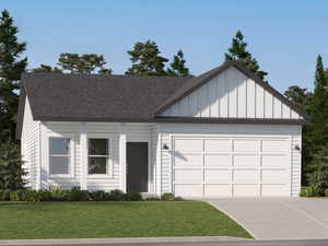 View of front facade with a garage and a front lawn