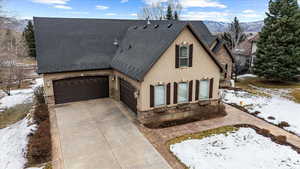 View of front of house with a mountain view and a garage