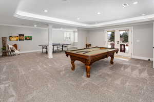 Playroom with billiards, ornamental molding, carpet, a tray ceiling, and french doors