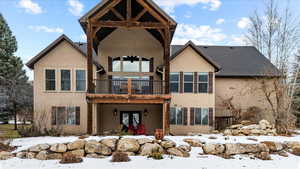 View of snow covered back of property