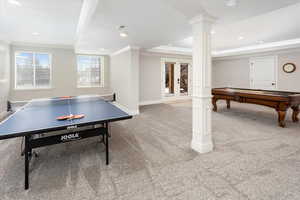 Recreation room featuring ornate columns, carpet flooring, ornamental molding, pool table, and a tray ceiling