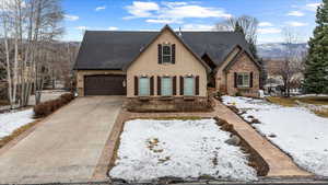 View of front facade featuring a garage and a mountain view