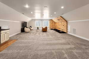 Interior space featuring lofted ceiling and carpet