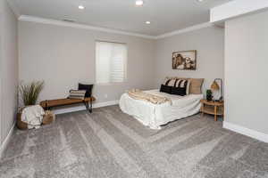 Bedroom featuring ornamental molding and carpet